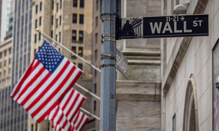 The sign for Wall Street with U.S. flags outside the New York Stock Exchange in New York on June 16, 2022. (Yuki Iwamura/AFP via Getty Images)