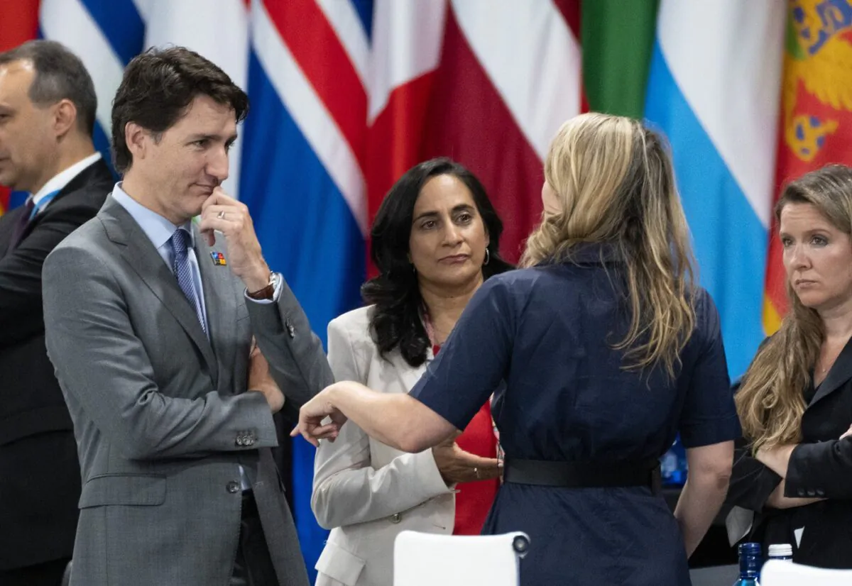 Prime Minister Justin Trudeau and Defence Minister Anita Annad listen to Minister for Foreign Affairs Melanie Joly prior to the opening session at the NATO Summit in Madrid on June 29, 2022. (The Canadian Press/Paul Chiasson)
