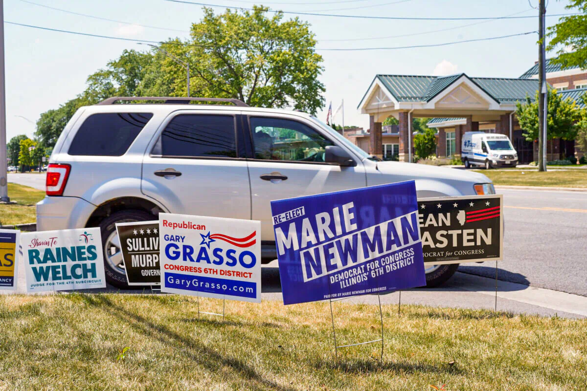Campaign signs are seen outside of a polling location in Palos Hills, IL on primary day on June 28, 2022. (Cara Ding/The Epoch Times)