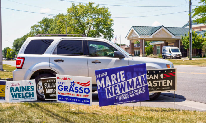 Campaign signs are seen outside of a polling location in Palos Hills, IL on primary day on June 28, 2022. (Cara Ding/The Epoch Times)