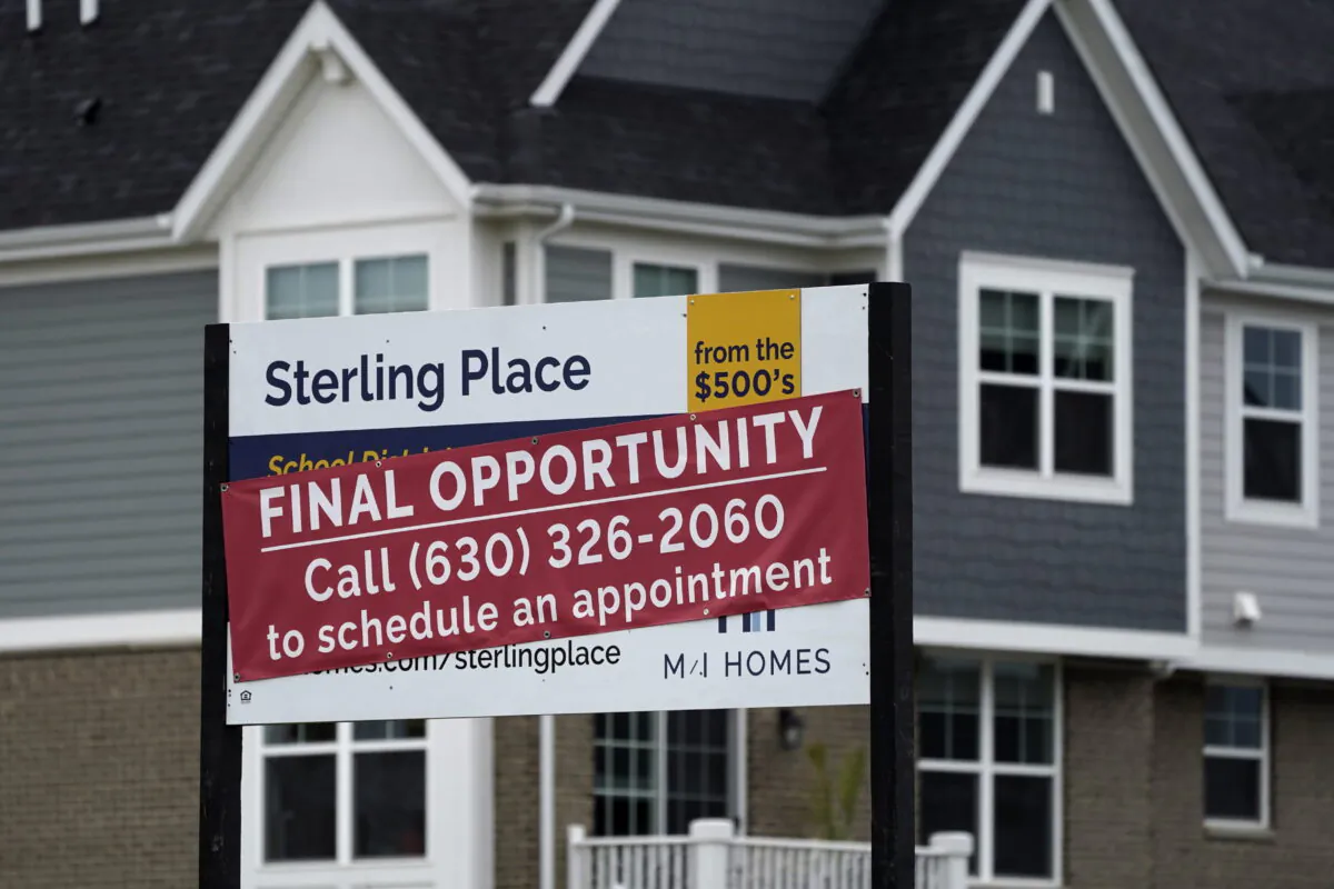 An advertising sign for building land stands in front of a new home construction site in Northbrook, Ill., on May 5, 2022. (Nam Y. Huh/AP Photo)