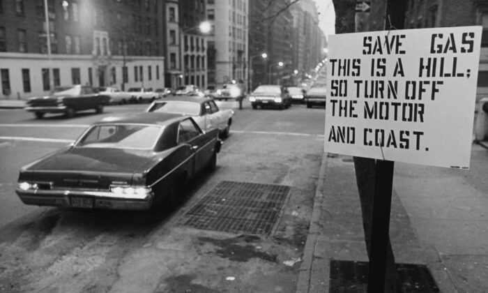 A sign by a road urging drivers to save fuel during the oil crisis of 1973-74 in the United States. The sign reads: 'Save gas; This is a hill, so turn off the motor and coast.' (Archive Photos/Getty Images)