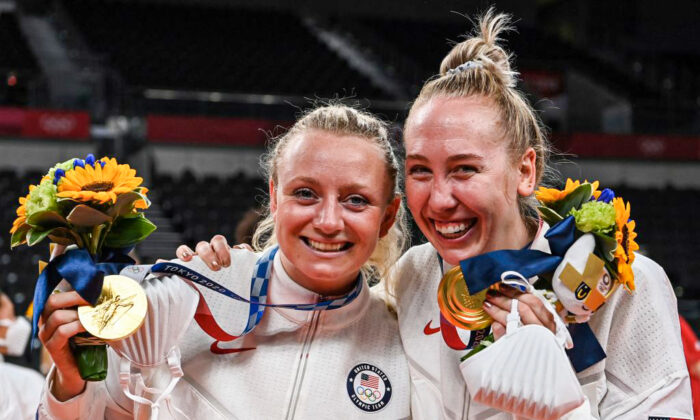 USA's Jordyn Poulter (L) and Michelle Bartsch-Hackley pose with their gold medals during the women's volleyball victory ceremony during the Tokyo 2020 Olympic Games at Ariake Arena in Tokyo on Aug. 8, 2021. (Yuri Cortez/AFP via Getty Images)