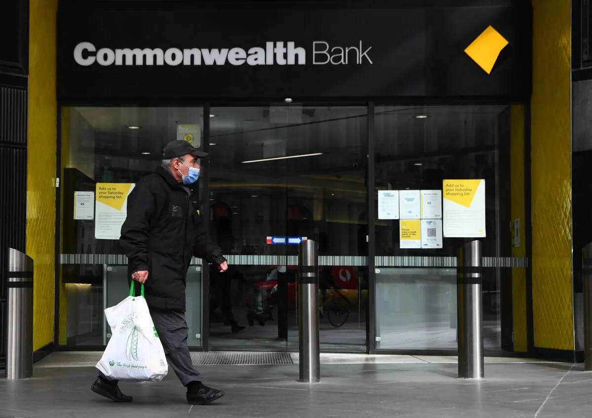 People walk past a branch of the Commonwealth Bank of Australia branch in Melbourne, on Aug. 11, 2021. (William West/AFP via Getty Images)
