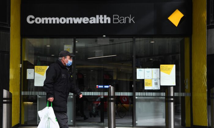 People walk past a branch of the Commonwealth Bank of Australia branch in Melbourne, on Aug. 11, 2021. (William West/AFP via Getty Images)