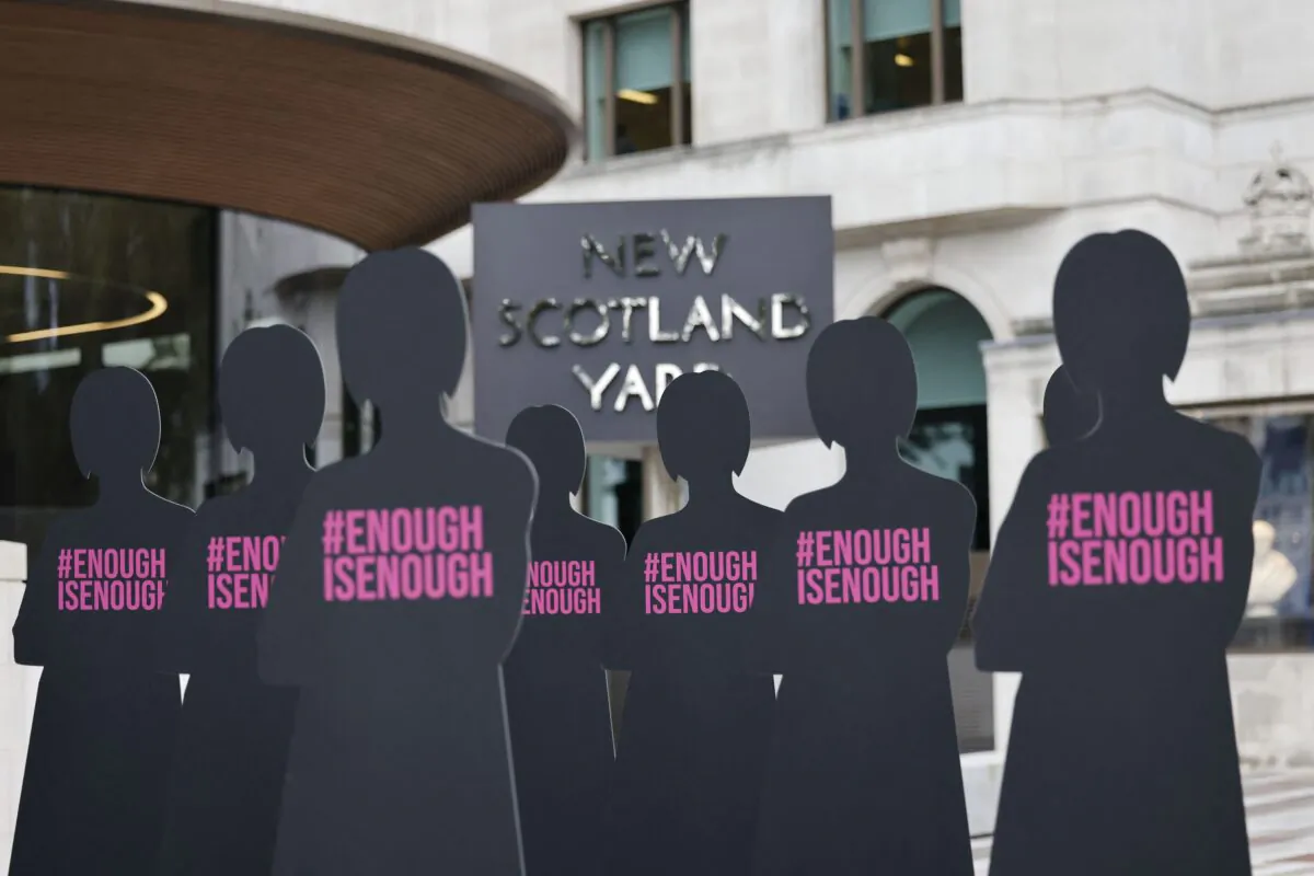 Cut-out silhouettes representing women are set up outside the Metropolitan Police headquarters New Scotland Yard in an action by Refuge, the domestic abuse charity, to highlight the issue of women who have been killed by male police officers or former police officers, in London on Oct. 7, 2021. (Tolga Akmen/AFP via Getty Images)