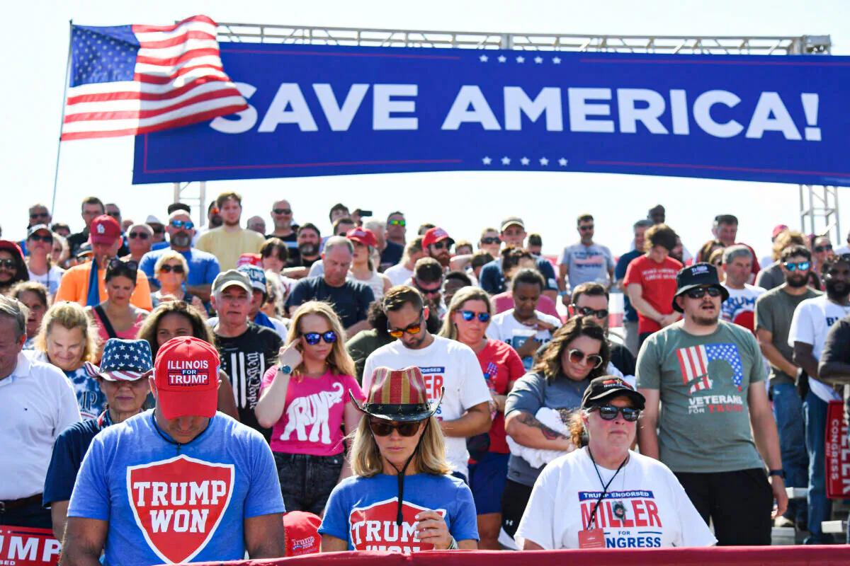 Supporters of former US President Donald Trump pray the Save America Rally at the Adams County Fairgrounds on June 25, 2022 in Mendon, Illinois.(Michael B. Thomas/Getty Images)