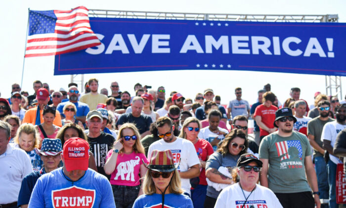 Supporters of former President Donald Trump pray at the Save America Rally at the Adams County Fairgrounds in Mendon, Ill., on June 25, 2022. (Michael B. Thomas/Getty Images)