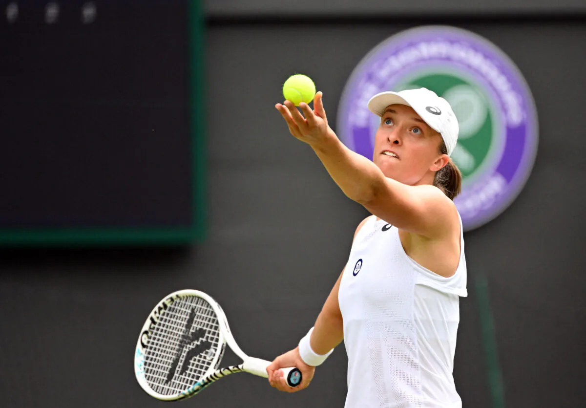 Poland's Iga Swiatek serves to Netherlands' Lesley Pattinama Kerkhove during their women's singles tennis match on the fourth day of the 2022 Wimbledon Championships at The All England Tennis Club in Wimbledon, southwest London, on June 30, 2022. (Sebastien Bozon/AFP via Getty Images)