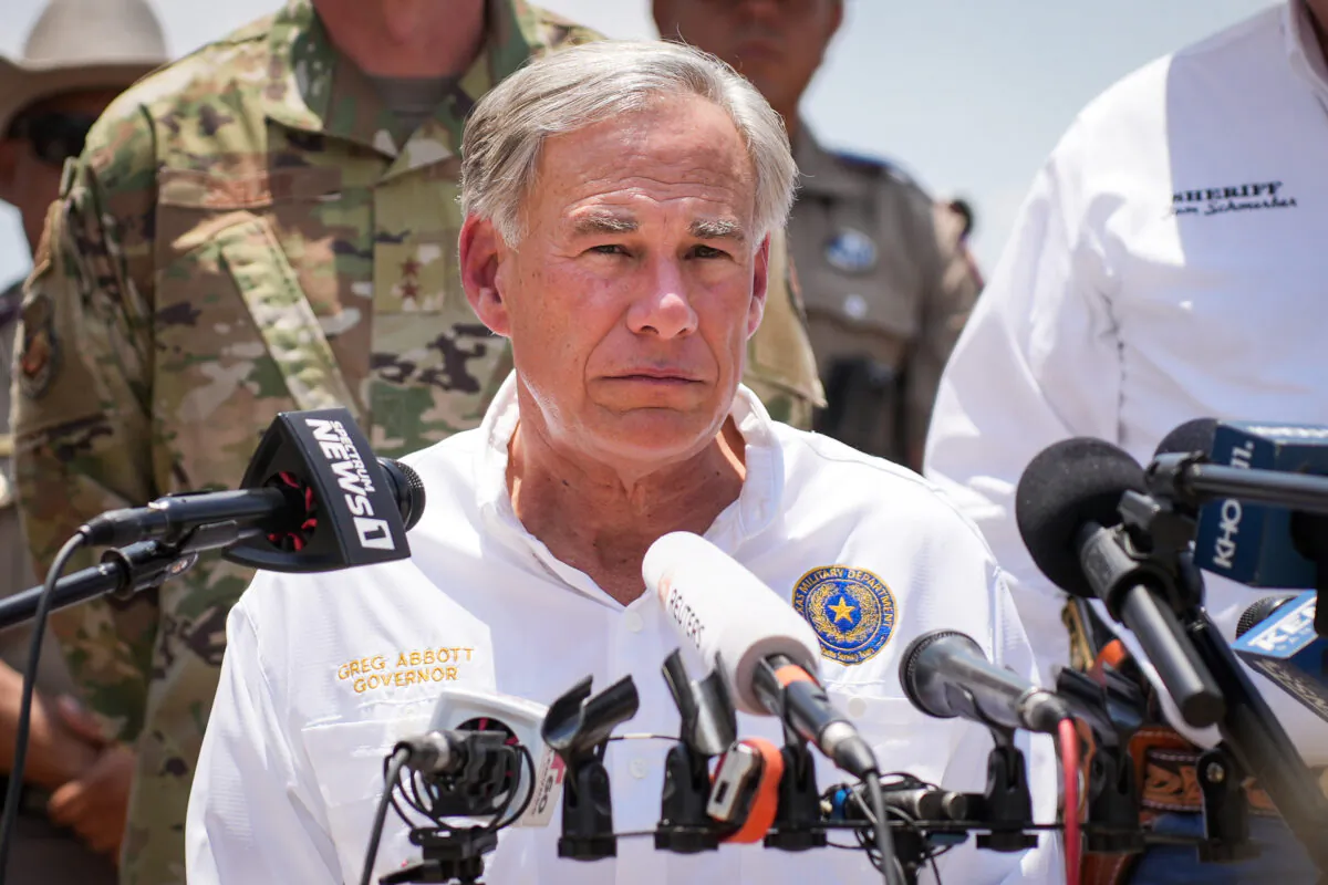 Texas Gov. Greg Abbott, flanked by state and local law enforcement officials, speaks to media in Eagle Pass, Texas, on June 29, 2022. (Charlotte Cuthbertson/The Epoch Times)