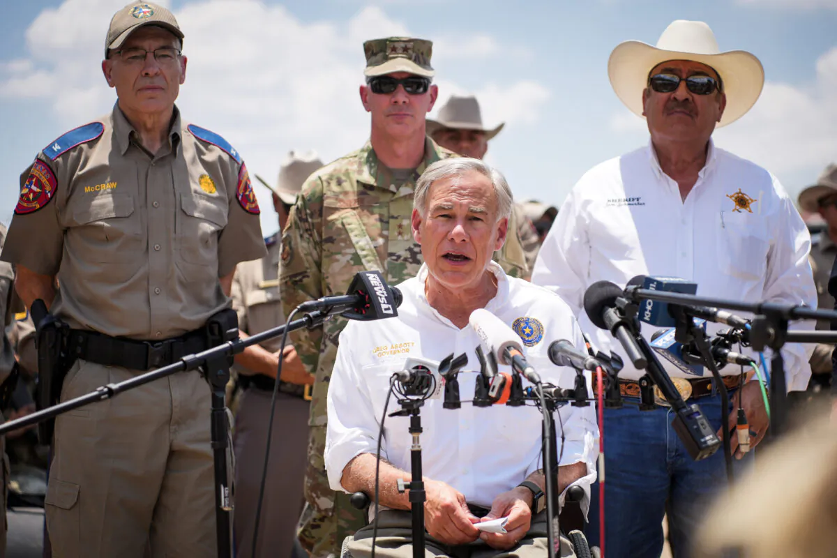 Texas Gov. Greg Abbott, flanked by state and local law enforcement officials, speaks to media in Eagle Pass, Texas, on June 29, 2022. (Charlotte Cuthbertson/The Epoch Times)