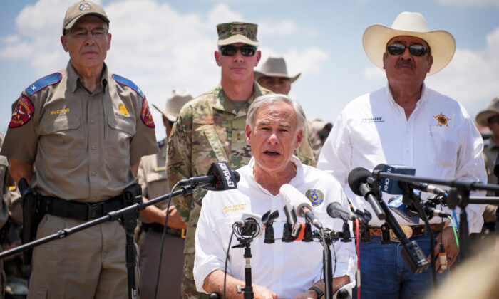 Texas Gov. Greg Abbott, flanked by state and local law enforcement officials, speaks to media in Eagle Pass, Texas, on June 29, 2022. (Charlotte Cuthbertson/The Epoch Times)