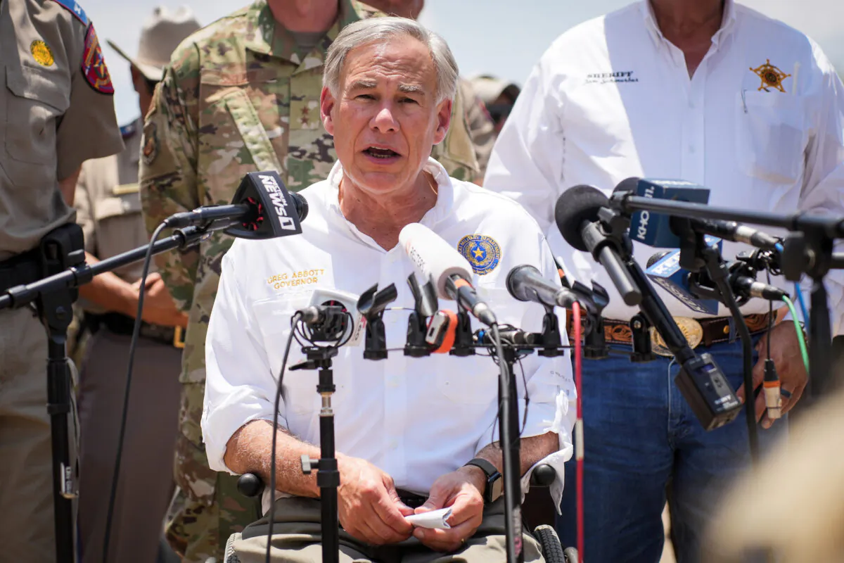 Texas Gov. Greg Abbott, flanked by state and local law enforcement officials, speaks to media in Eagle Pass, Texas, on June 29, 2022. (Charlotte Cuthbertson/The Epoch Times)