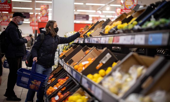 Customers at the fruit and vegetable section at a Sainsbury's supermarket in Walthamstow in London on Feb. 13, 2022. (Tolga Akmen/AFP via Getty Images)