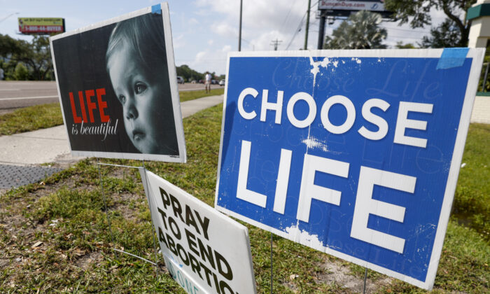 Pro-life signs are seen outside the All Women’s Health Center of Clearwater on May 3. The Supreme Court has struck down the landmark 1973 Roe v. Wade case that recognized a Constitutional right to an abortion. States can now ban the procedure. (TNS)