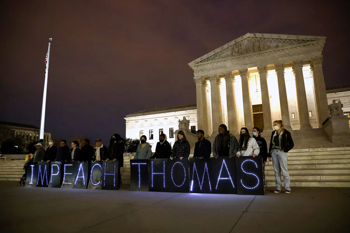 MoveOn activists call for the impeachment of Justice Clarence Thomas outside of the U.S. Supreme Court in Washington on March 30, 2022. (Paul Morigi/Getty Images for MoveOn)