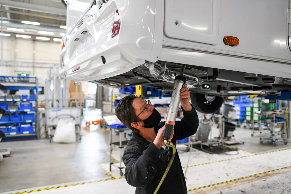 A worker assembles a vehicle at the Knaus-Tabbert AG factory in Jandelsbrunn near Passau, Germany, on March 16, 2021. (Andreas Gebert/Reuters)