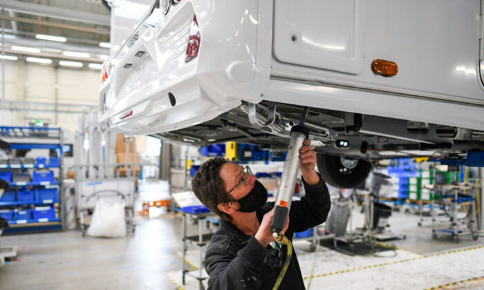 A worker assembles a vehicle at the Knaus-Tabbert AG factory in Jandelsbrunn near Passau, Germany, on March 16, 2021. (Andreas Gebert/Reuters)