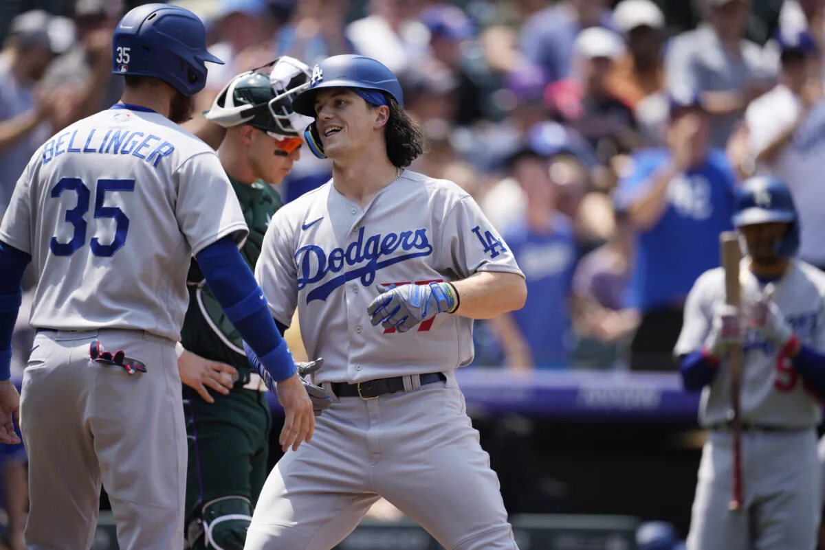Los Angeles Dodgers' Cody Bellinger, left, congratulates James Outman as he crosses home plate after hitting a two-run home run off Colorado Rockies starting pitcher German Marquez in the third inning of a baseball game in Denver, Sunday, July 31, 2022. (David Zalubowski/AP Photo)