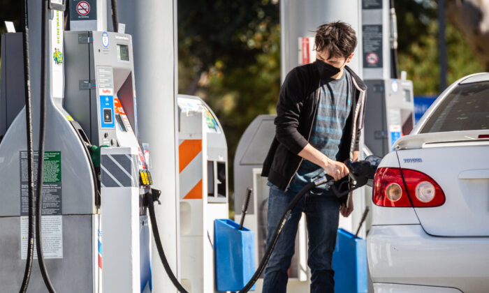 Gas stations serve customers at peak prices in Irvine, Calif., on Feb. 23, 2022. (John Fredricks/The Epoch Times)