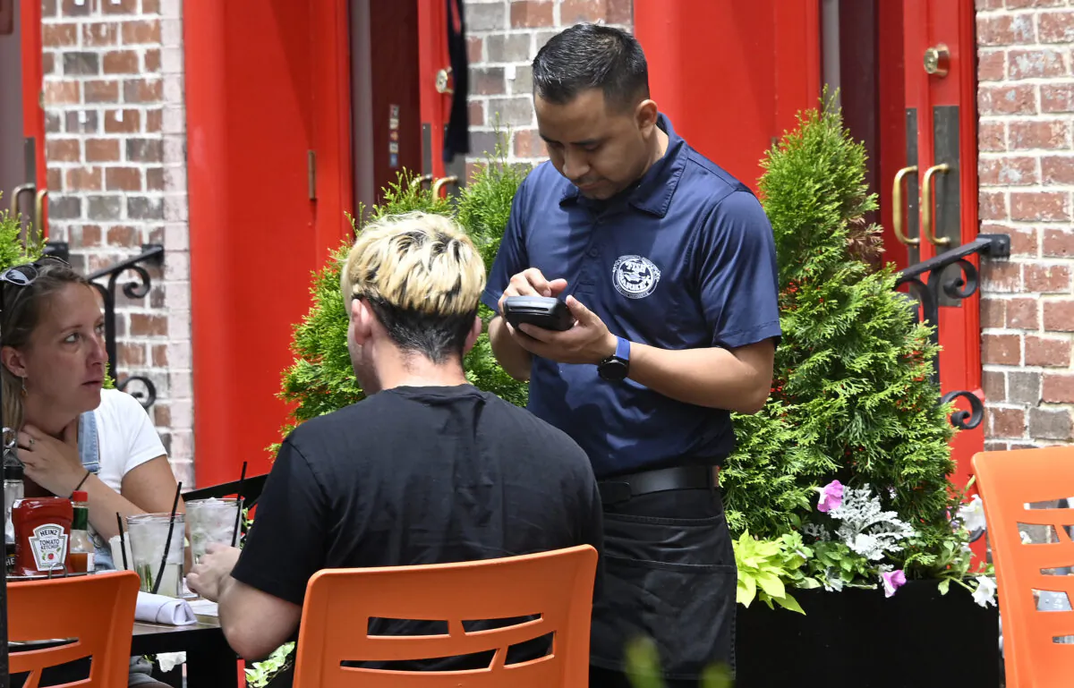A waiter works at a restaurant in Alexandria, Virginia, on June 3, 2022. (Olivier Douliery/AFP via Getty Images)