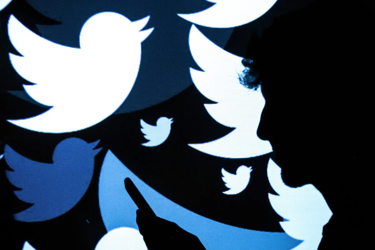 Twitter's logo is projected onto a man in London on Aug. 9, 2017. (Leon Neal/Getty Images)