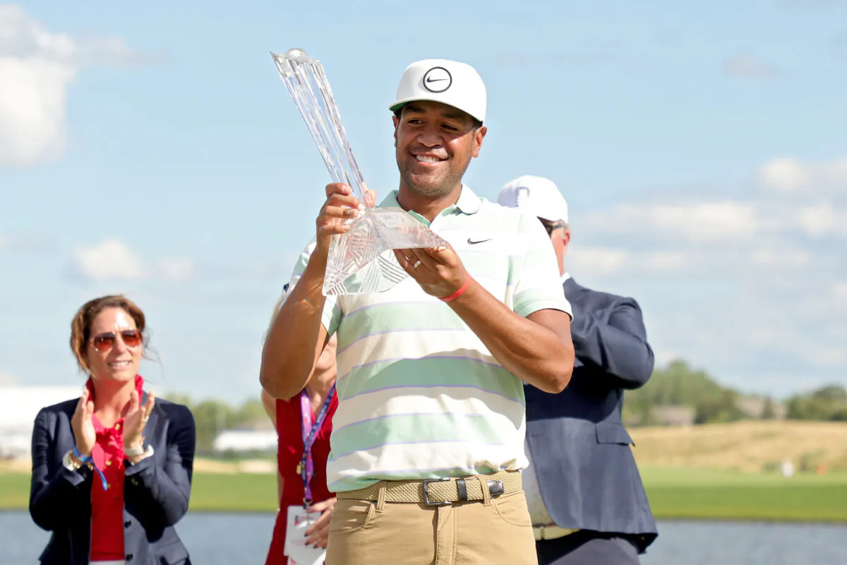 Tony Finau of the United States celebrates with the trophy after winning the 3M Open at TPC Twin Cities in Blaine, Minn., on July 24, 2022. (Stacy Revere/Getty Images)