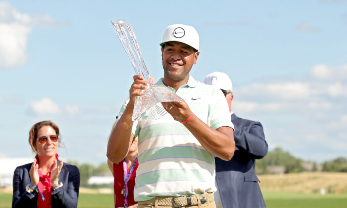 Tony Finau of the United States celebrates with the trophy after winning the 3M Open at TPC Twin Cities in Blaine, Minn., on July 24, 2022. (Stacy Revere/Getty Images)