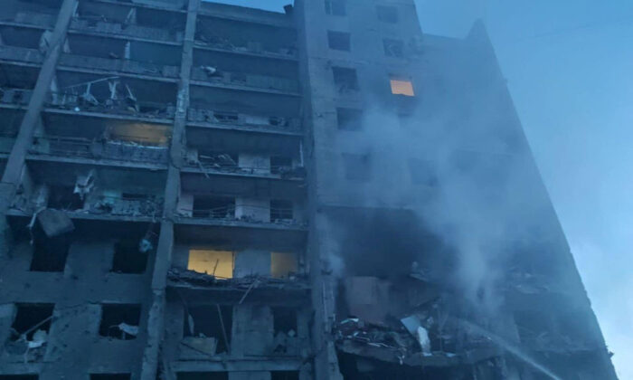 Rescue workers work at the scene of a missile strike at a location given as Bilhorod-Dnistrovskyi, Odesa region, Ukraine, in this handout image released on July 1, 2022. (State Emergency Services of Ukraine/Handout via Reuters)