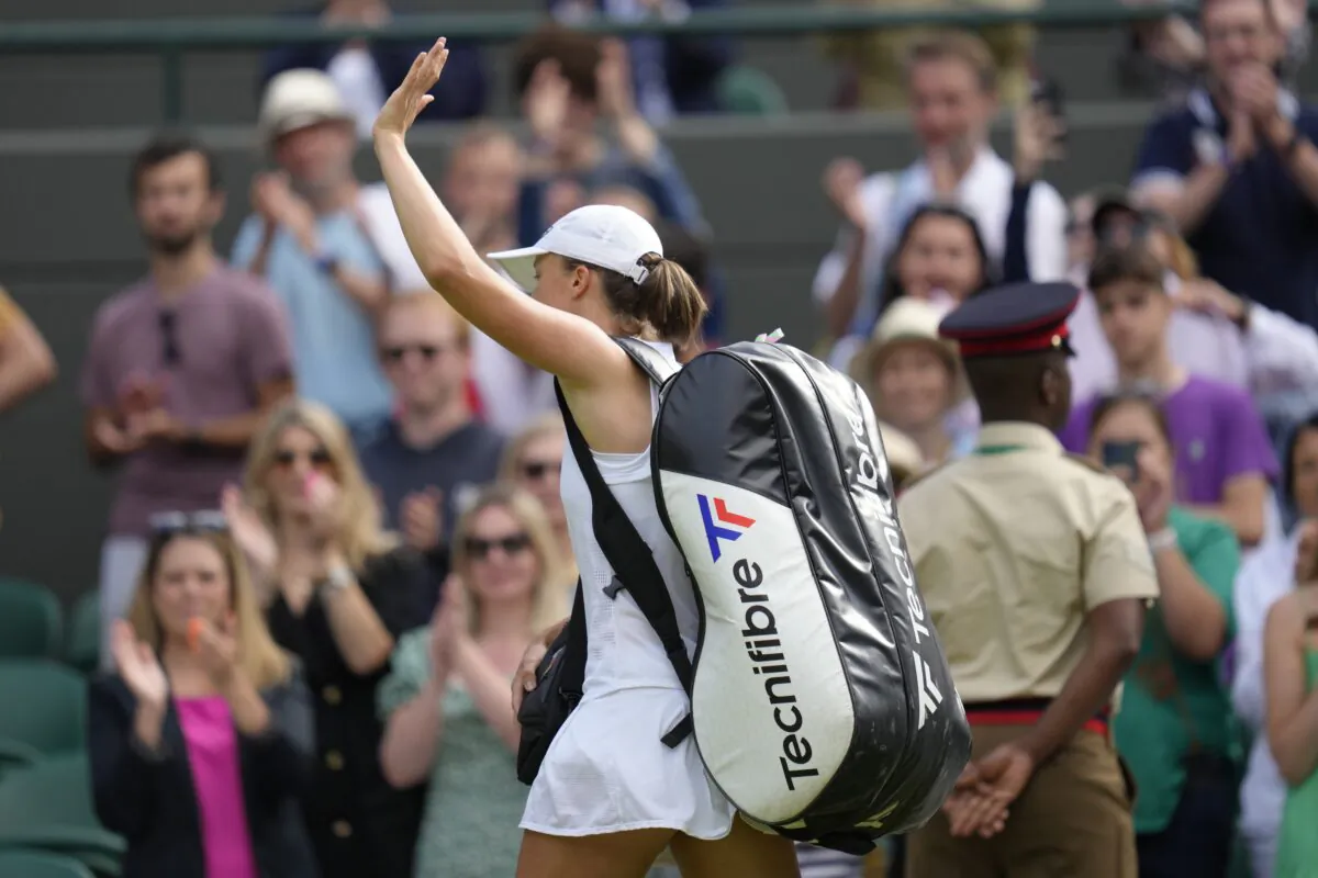 Poland's Iga Swiatek leaves the court after losing to France's Alize Cornet in a third round women's singles match on day six of the Wimbledon tennis championships in London on July 2, 2022. (Kirsty Wigglesworth/AP Photo)