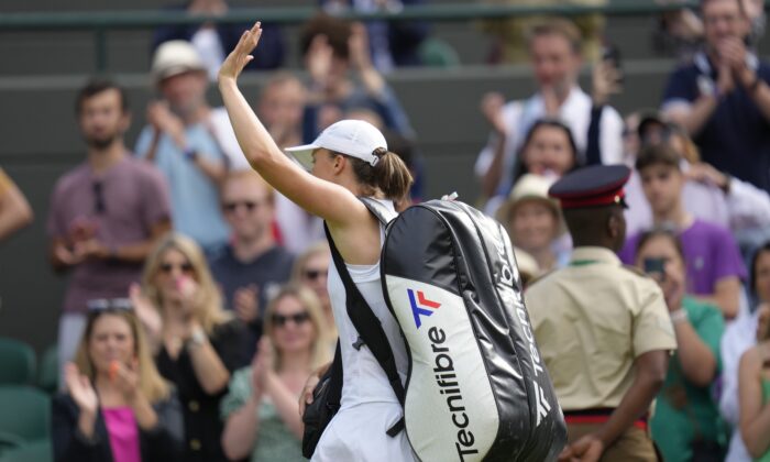Poland's Iga Swiatek leaves the court after losing to France's Alize Cornet in a third round women's singles match on day six of the Wimbledon tennis championships in London on July 2, 2022. (Kirsty Wigglesworth/AP Photo)