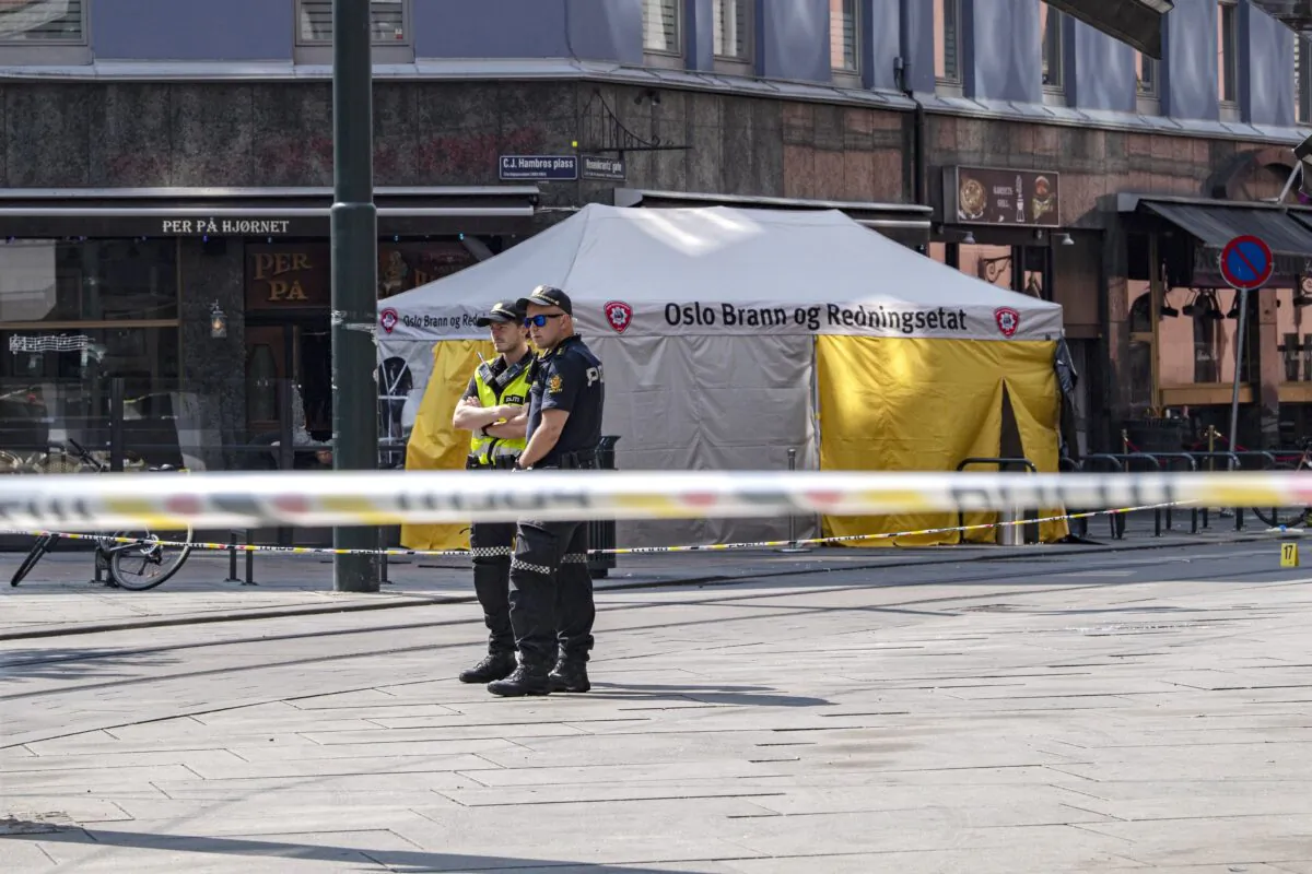 Police stand near a restaurant whose windows were shattered by a shooting in Oslo, Norway, on June 25, 2022. (Rodrigo Freitas/Getty Images)
