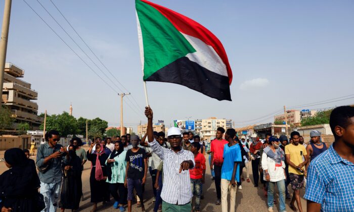 Protesters march during a rally against military rule, following the last coup and to commemorate the 3rd anniversary of demonstrations in Khartoum North, Sudan, on July 1, 2022. (Mohamed Nureldin Abdallah/Reuters)