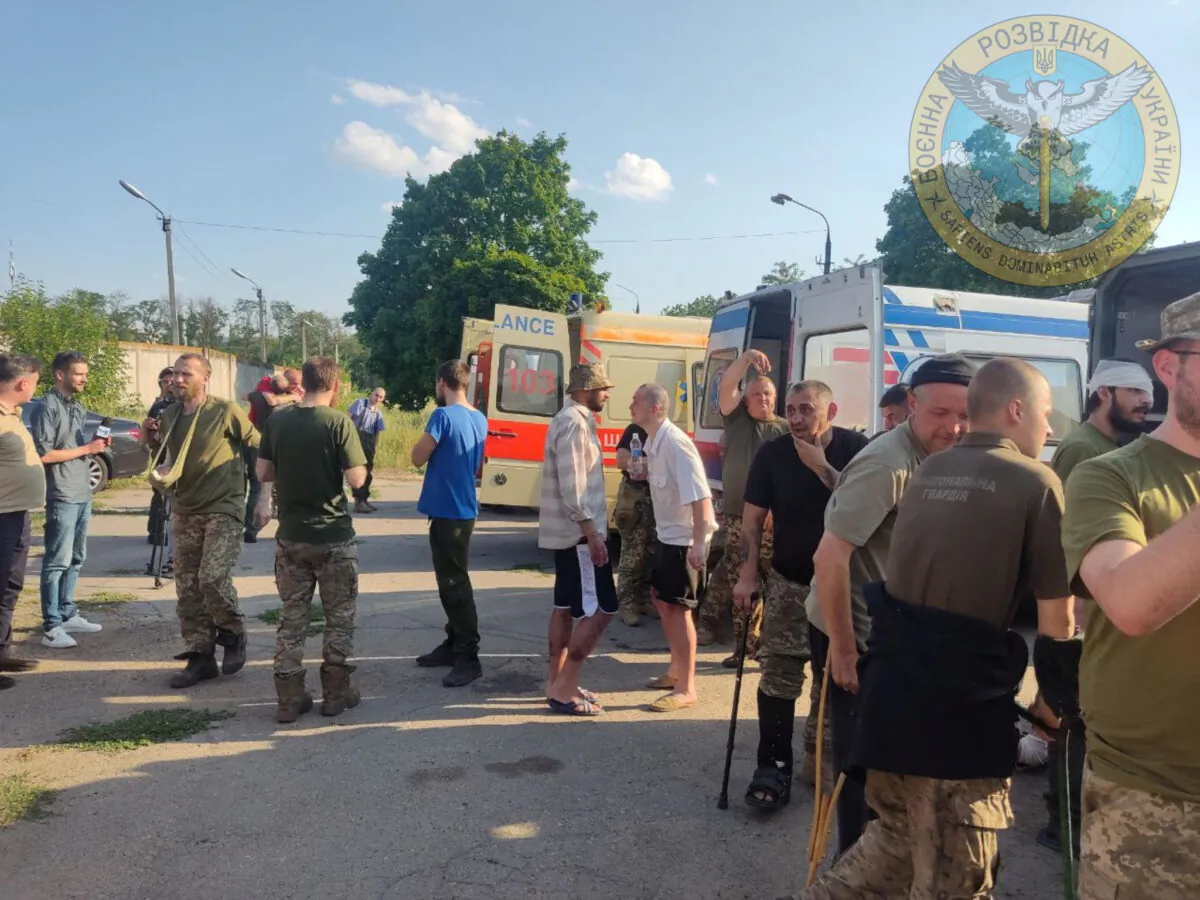 Ukrainian soldiers stand next to ambulances as Ukraine carries out an exchange of prisoners in the location given as Zaporizhzhia, Ukraine, in this handout photo released on June 29, 2022. (Courtesy of Ukraine's Military Intelligence/Handout via Reuters)