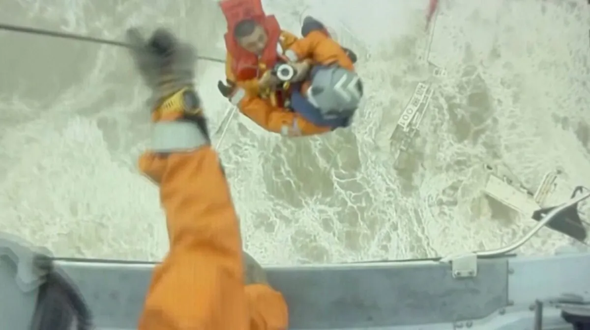 Rescuers lift a crew member of a sinking vessel into a helicopter, after it snapped in two as tropical storm Chaba passed through, in waters off Hong Kong in this screen grab taken from a video on July 2, 2022. (Hong Kong Government Flying Service/Handout via Reuters)