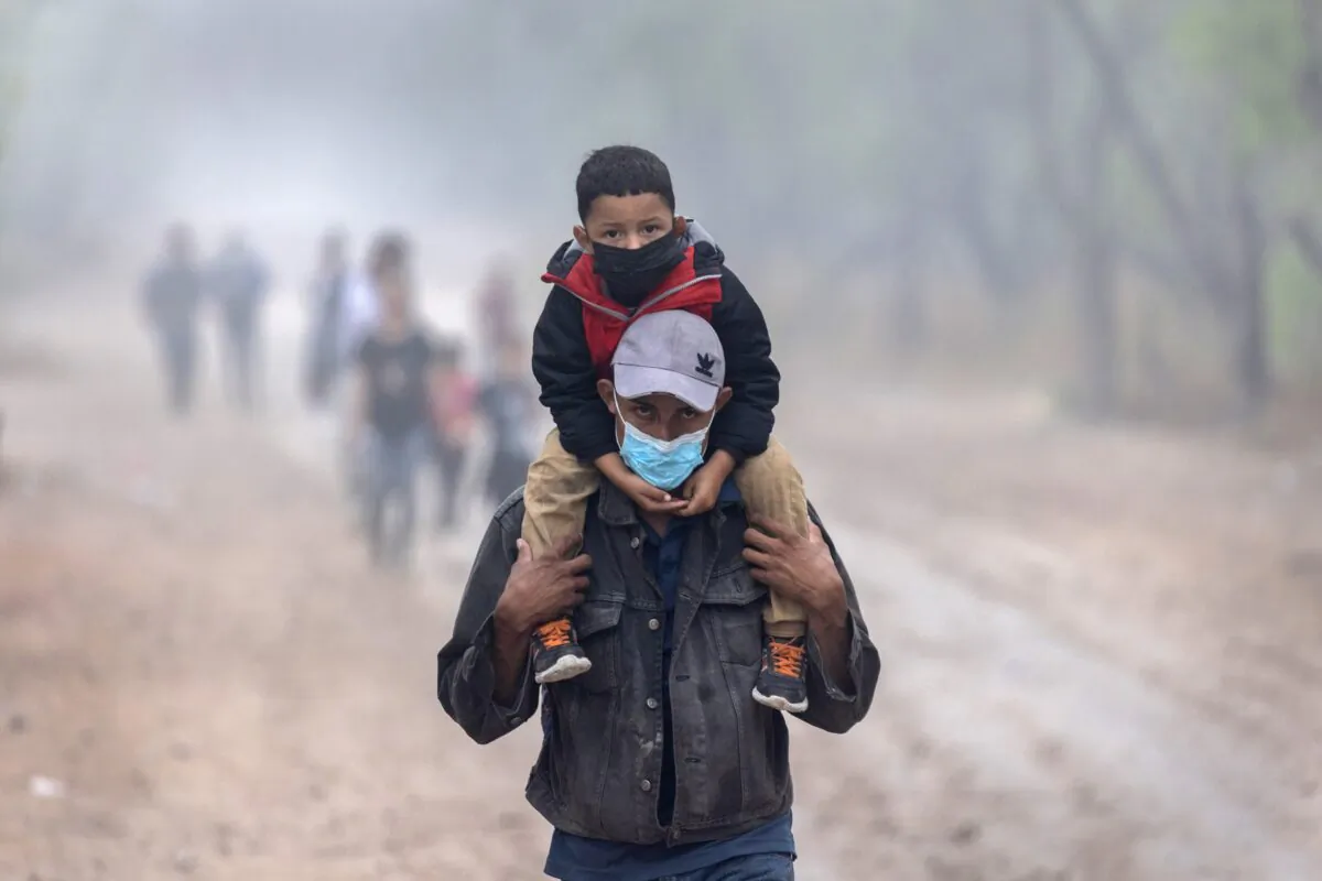 Central American families walk towards U.S. Border Patrol agents near the U.S.-Mexico border, in La Joya, Texas, on April 10, 2021. (John Moore/Getty Images)