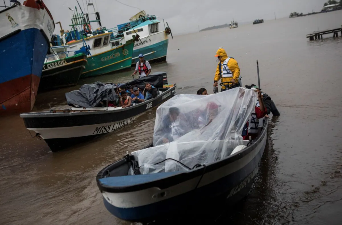 People leave the port by boat to return their communities amid the arrival of Tropical Storm Bonnie in Bluefields, Nicaragua, on July 1, 2022. (Inti Ocon/AP Photo)