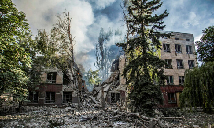 Smoke rises over the remains of a building destroyed by a military strike, as Russia's attack on Ukraine continues, in Lysychansk, Luhansk region, Ukraine, on June 17, 2022.  (Oleksandr Ratushniak/Reuters)