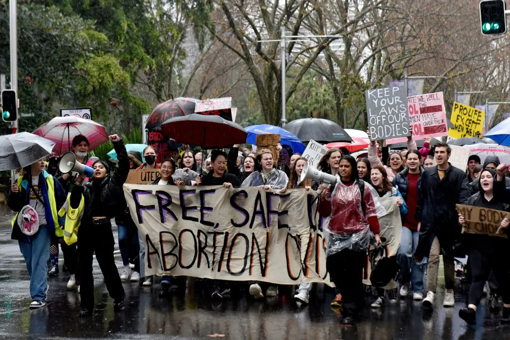 Protestors carry a banner march through the streets during a rally in support of abortion rights in the central business district of Sydney, Australia, on July 2, 2022. (MUHAMMAD FAROOQ/AFP via Getty Images)