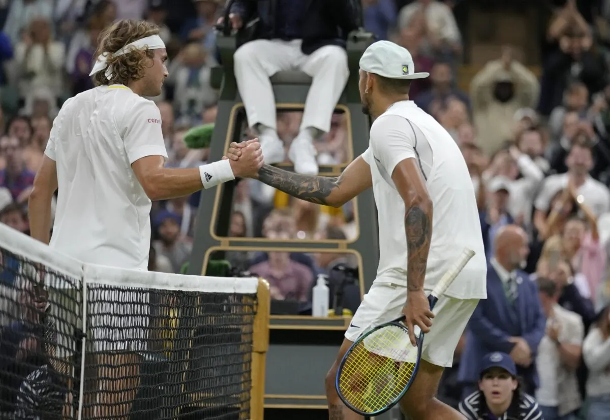 Australia's Nick Kyrgios shakes hands at the net with Greece's Stefanos Tsitsipas after winning their third round men's singles match on day six of the Wimbledon tennis championships in London on July 2, 2022. (Kirsty Wigglesworth/AP Photo)