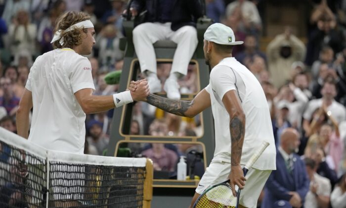 Australia's Nick Kyrgios shakes hands at the net with Greece's Stefanos Tsitsipas after winning their third round men's singles match on day six of the Wimbledon tennis championships in London on July 2, 2022. (Kirsty Wigglesworth/AP Photo)