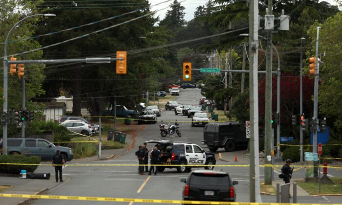 Saanich Police joined by Victoria Police and RCMP respond gunfire involving multiple people and injuries reported at the Bank of Montreal during an active situation in Saanich, B.C., on June 28, 2022. (The Canadian Press/Chad Hipolito)