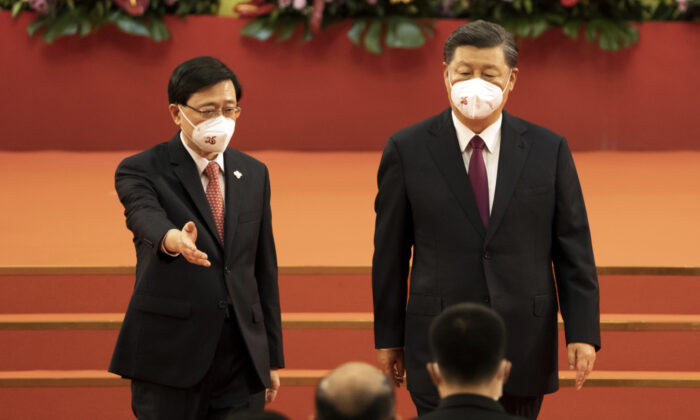 Xi Jinping, China Leader, right, and John Lee, Hong Kong's new chief executive, at a swearing-in ceremony in Hong Kong, China, on Friday, July 1, 2022. (Justin Chin/Bloomberg via Getty Images)