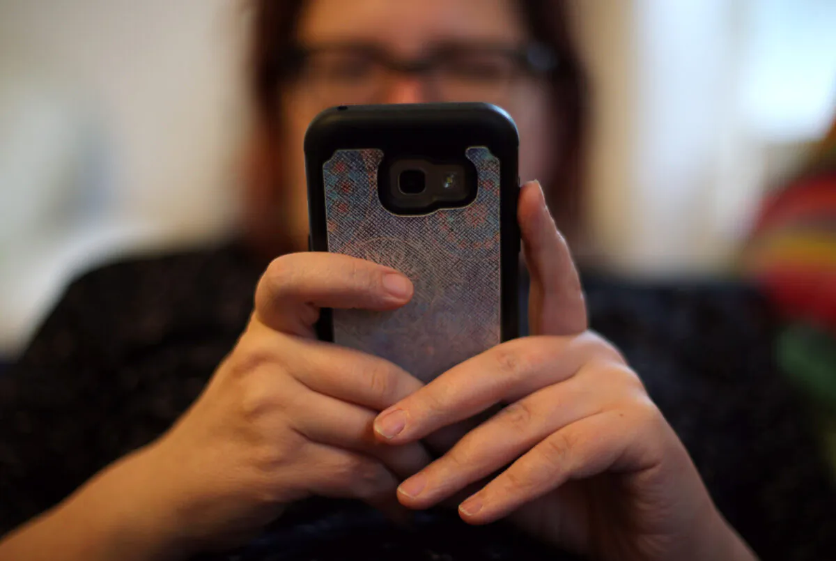 An unidentified woman uses her phone in London on May 18, 2019. (Yui Mok/PA)