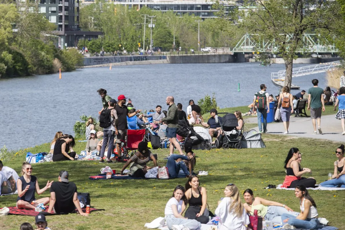 People gather next to the Lachine Canal in Montreal in a file photo. (The Canadian Press/Graham Hughes)