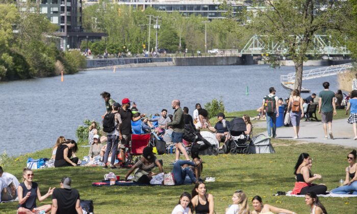 People gather next to the Lachine Canal in Montreal in a file photo. (The Canadian Press/Graham Hughes)