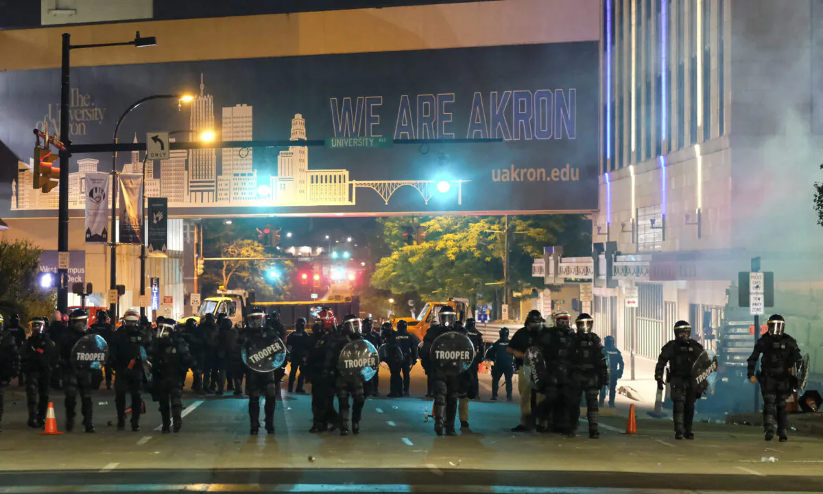 Troopers in riot gear and police officers deployed tear gas and stun grenades to clear the area around Akron City Hall and Akron Police Station during a protest over the killing of Jayland Walker, shot by police, in Akron, Ohio, on July 3, 2022. (Matthew Hatcher/AFP via Getty Images)