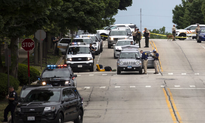 Law enforcement works the scene after a mass shooting at a Fourth of July parade in Highland Park, Ill., on July 4, 2022. (Jim Vondruska/Getty Images)
