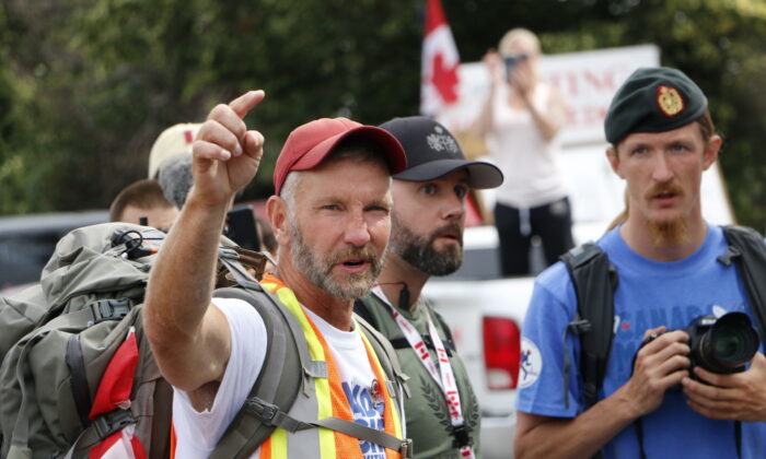 James Topp gives instructions to a group of supporters walking with him on the last day of his trek in Ottawa on June 30, 2022. (Noé Chartier/The Epoch Times)