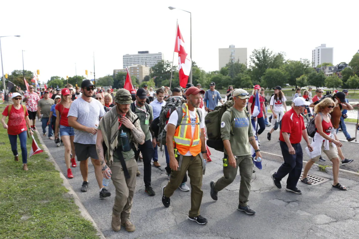 James Topp walks with supporters toward the National War Memorial in Ottawa on June 30, 2022. (Noé Chartier/The Epoch Times)